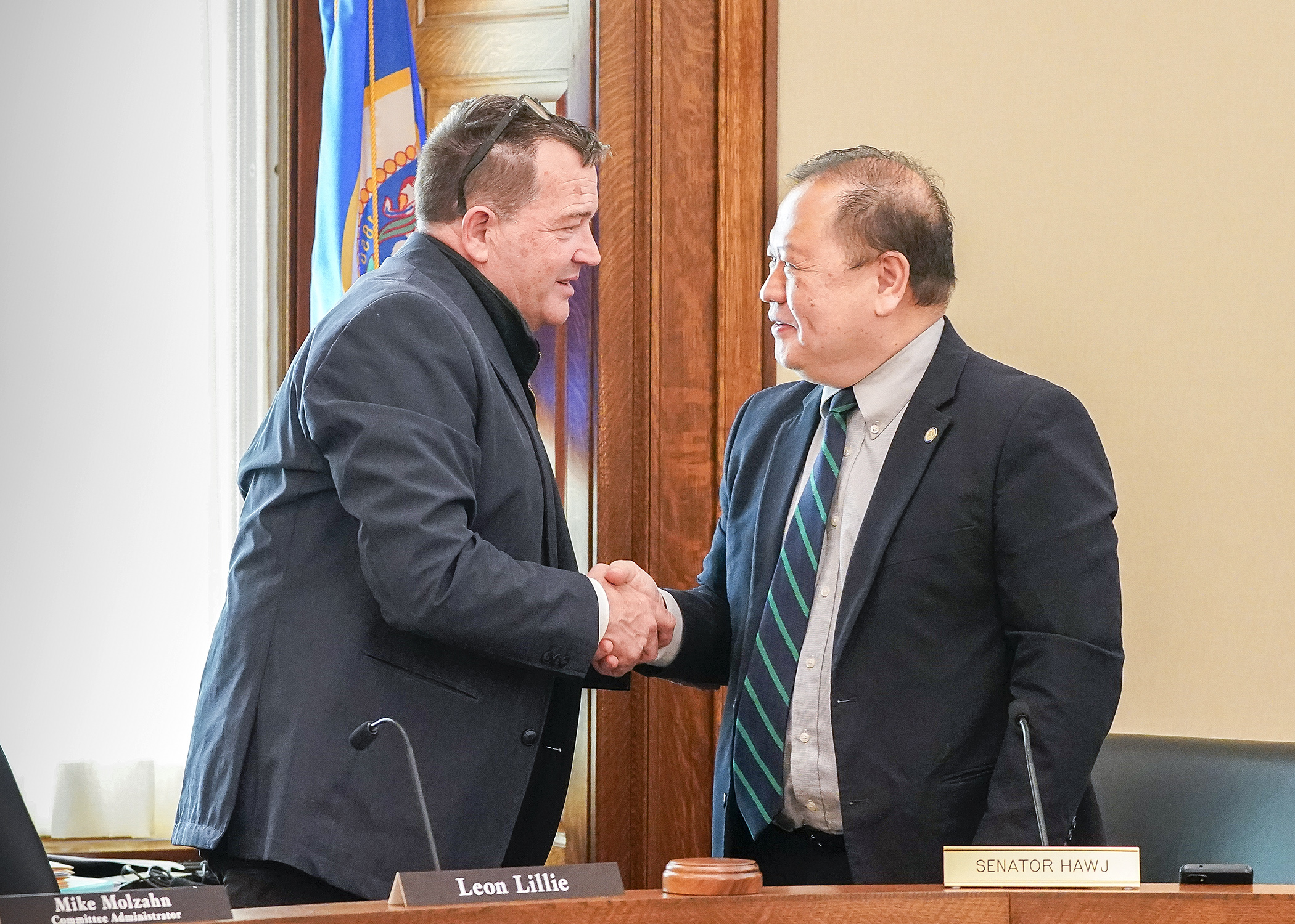 Rep. Leon Lillie and Sen. Foung Hawj concluded the final meeting of the Legacy conference committee with a handshake after an agreement was reached Friday. (Photo by Andrew VonBank)